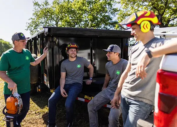 Group of Men Standing Beside Big Tex Trailer