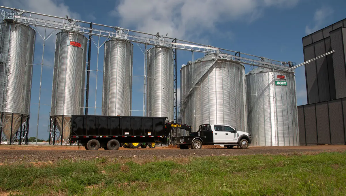Big Tex 25DU dump trailer hitched to white truck