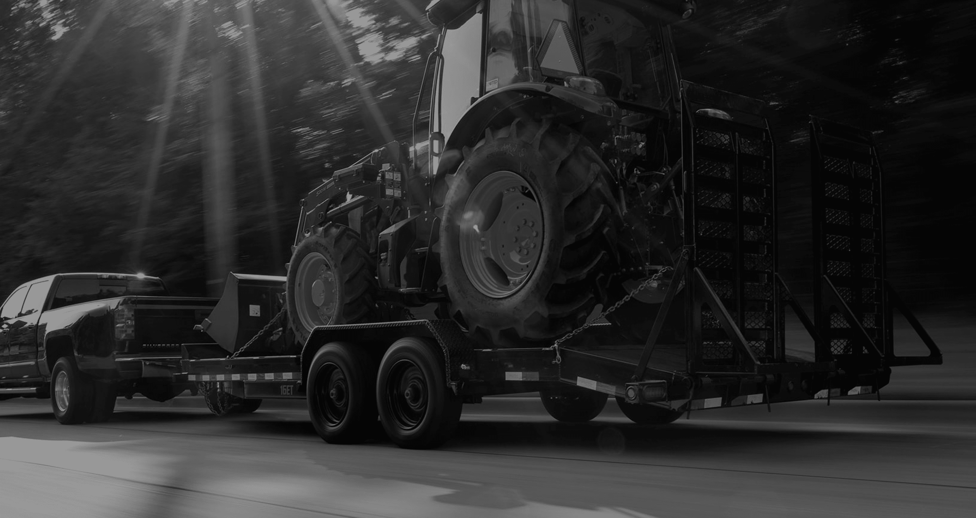 Truck with Trailer Carrying a Tractor