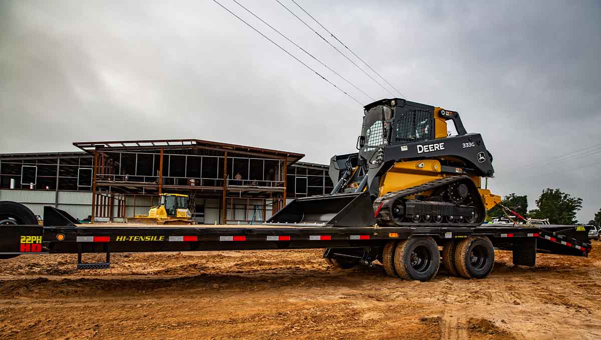 a 22ph gooseneck trailer with a deere tractor on it