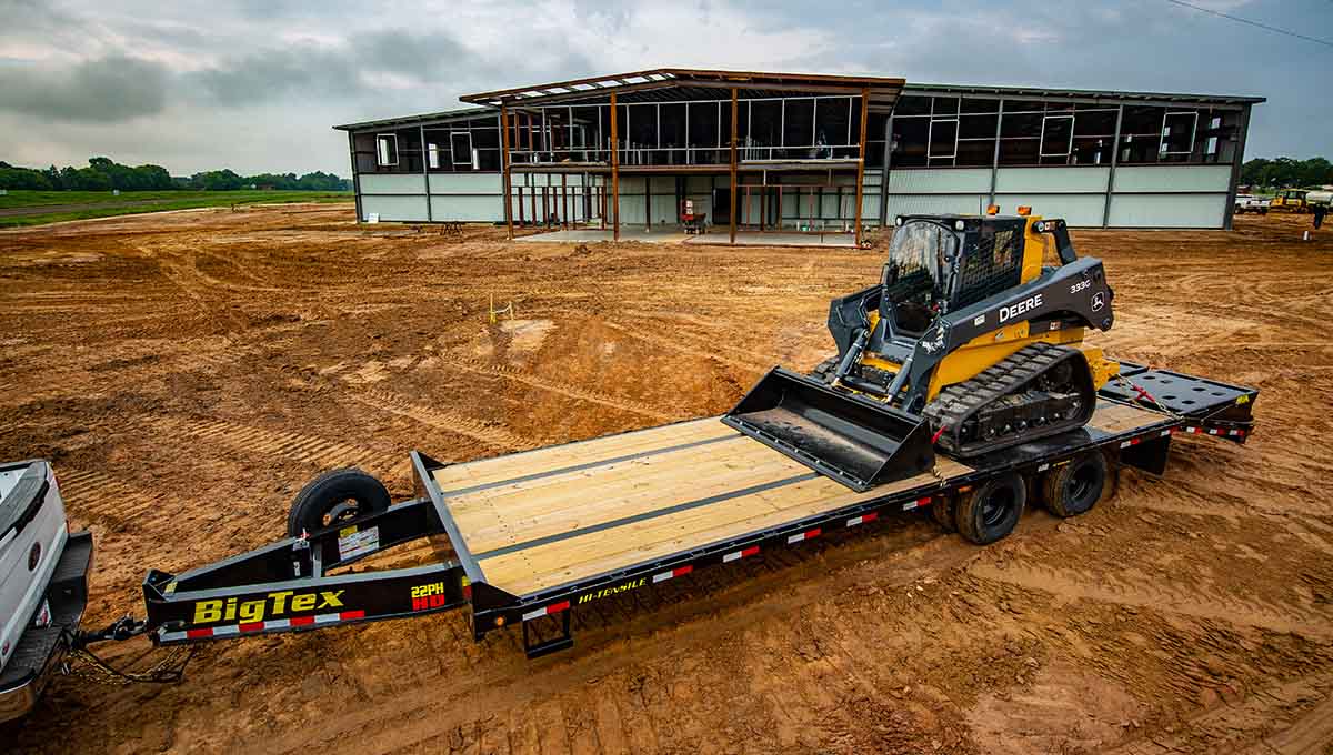 a 22ph gooseneck big tex trailer with a tractor on it