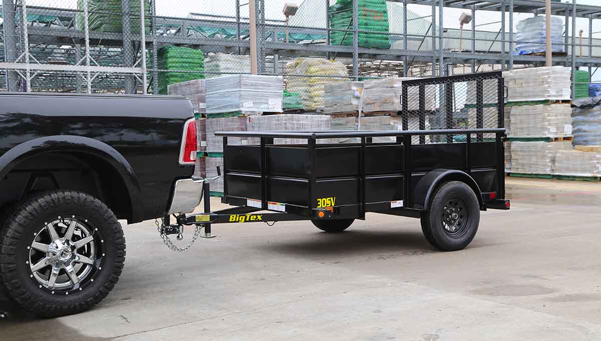 a black truck is pulling a 30sv trailer that says big tex