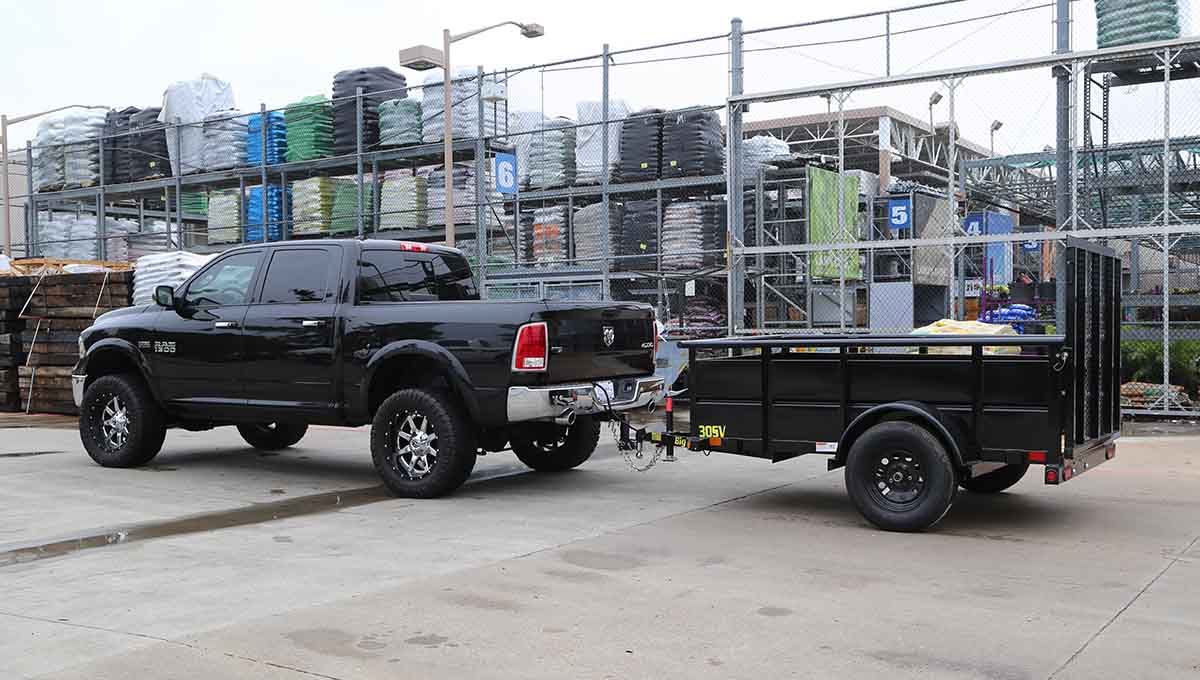 a black ram truck with a 30sv trailer attached to it