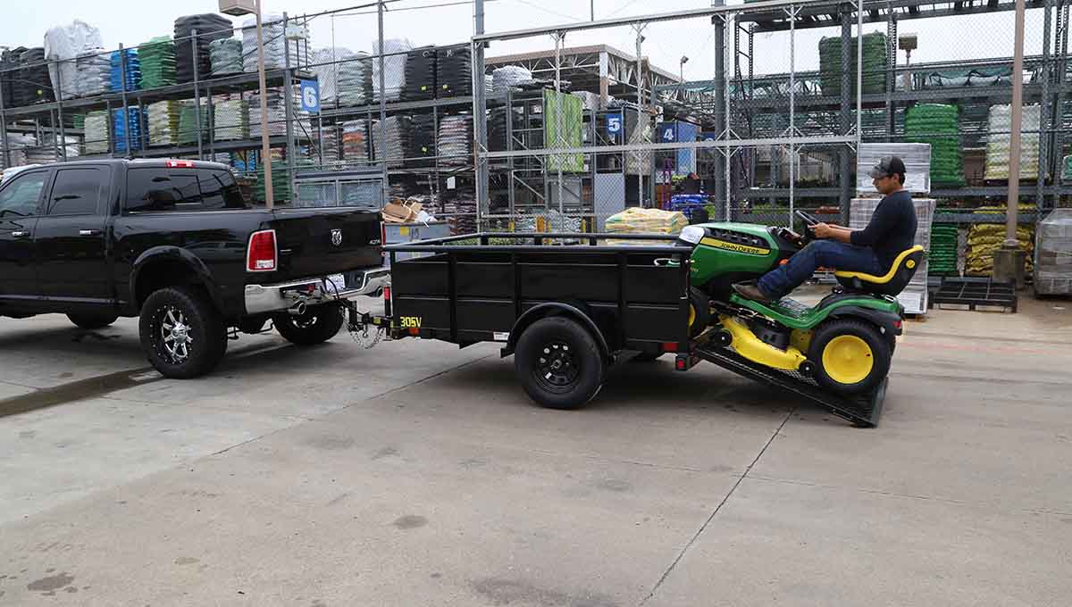 a john deere lawn mower is being towed by a 30sv vanguard trailer