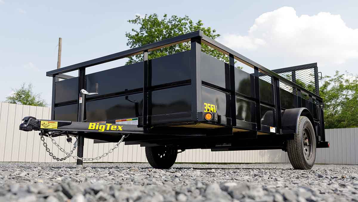 a black 35sv big tex trailer is parked on gravel