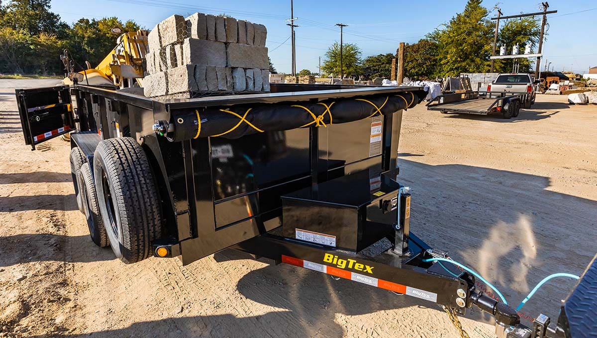 a big tex 12sr commercial dump trailer is loaded with bricks