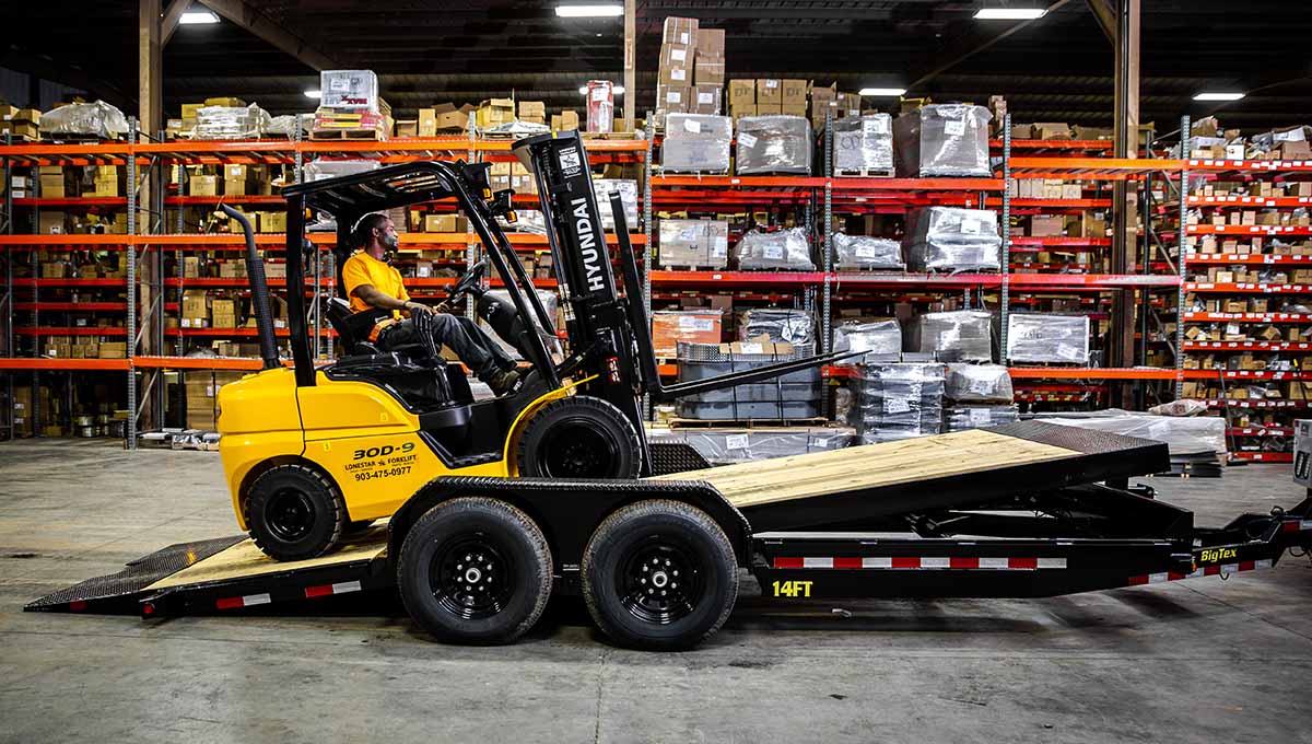 a man is driving a hyundai forklift in a warehouse