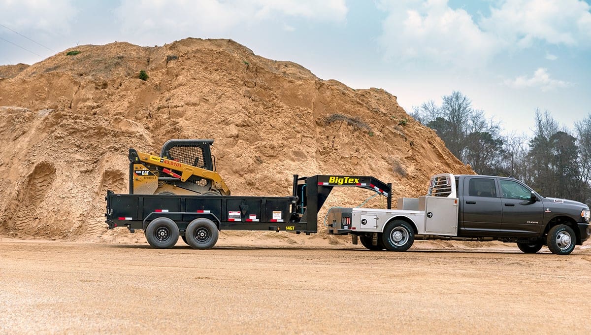 a ram truck is towing a 14gt commercial big tex dump trailer