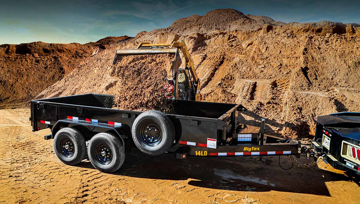 a 14ld big tex dump trailer is being pulled by a truck