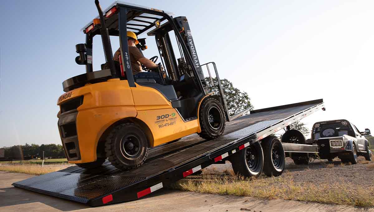 a yellow hyundai forklift is driving down a ramp