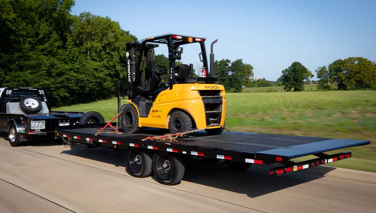 a yellow hyundai forklift on a 14ot flatbed trailer
