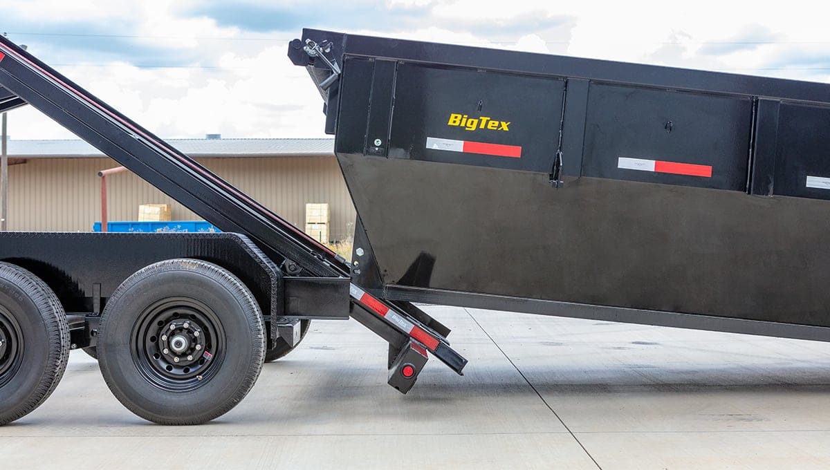 a big tex 14rb roll off dump trailer with a dumpster attached to it