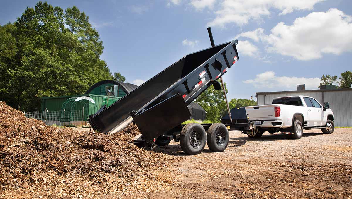 a white truck is pulling a 14td commercial grade dump trailer