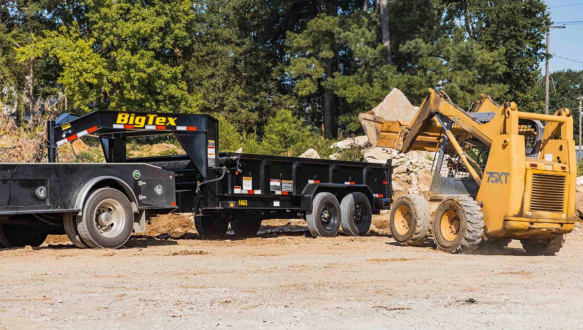 a 16gx commercial grade big tex dump trailer is being pulled by a tractor