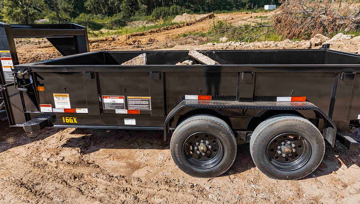 a 16gx commercial grade dump trailer in the grass