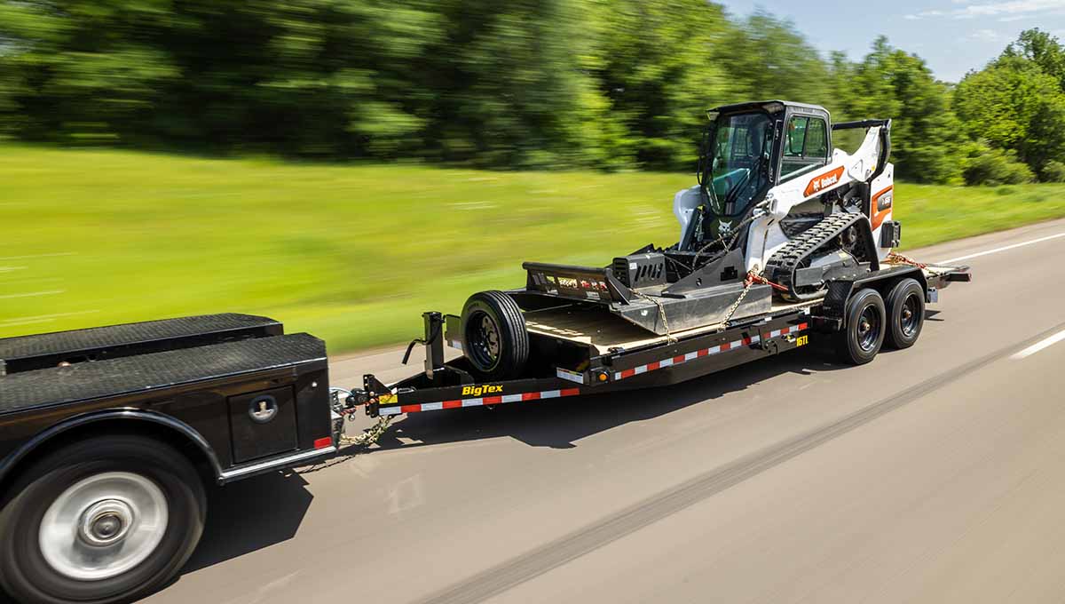 a bobcat is being towed by a 16tl big tex tilt trailer