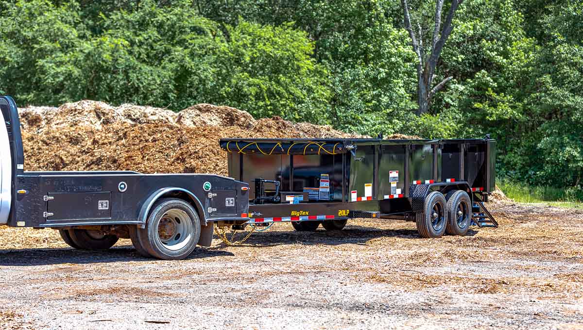 a 20lp big tex dump trailer is attached to a flatbed truck
