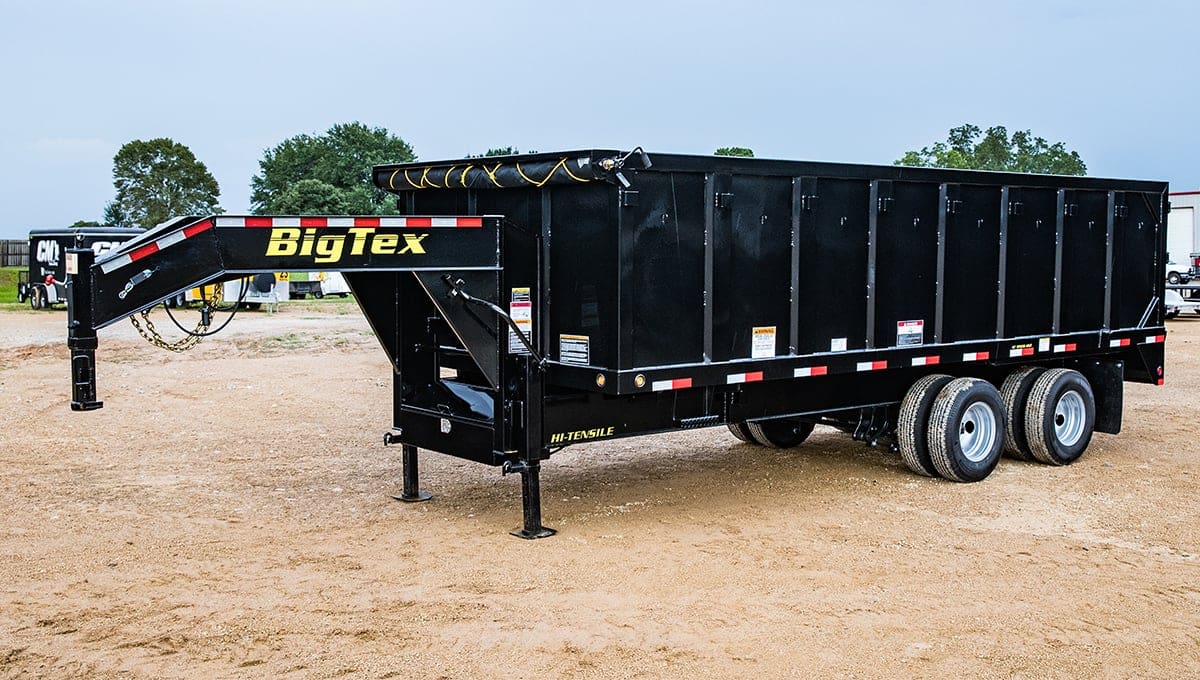 a big tex dump 25du trailer is parked in the dirt