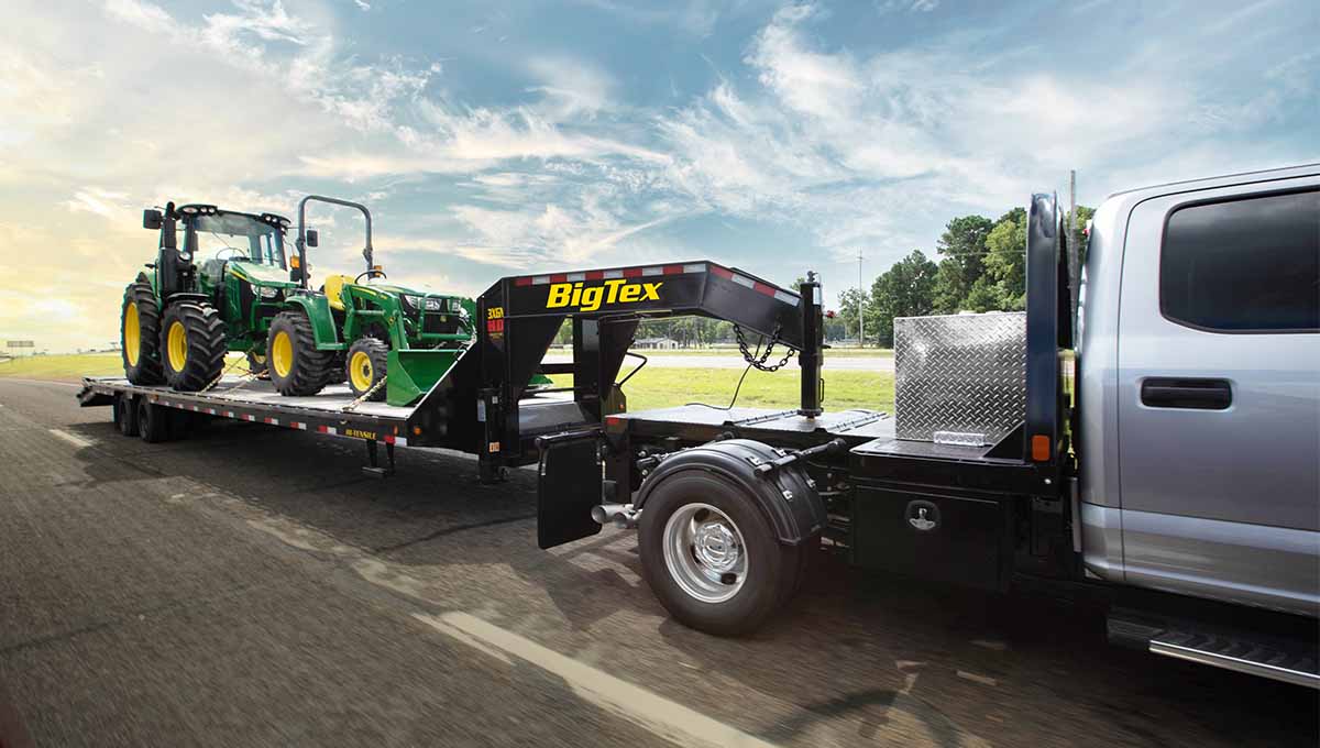 a tractor is being towed by a 3xgn biglex trailer