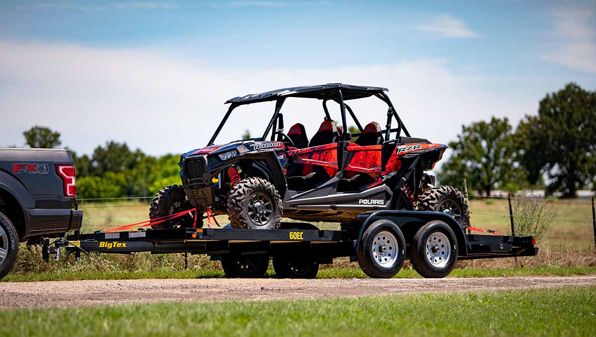 a polaris atv is being towed by a big tex trailer