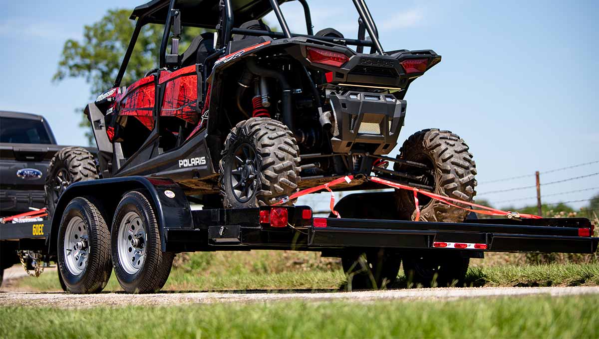 a polaris atv is being towed on a 60ec car hauler trailer