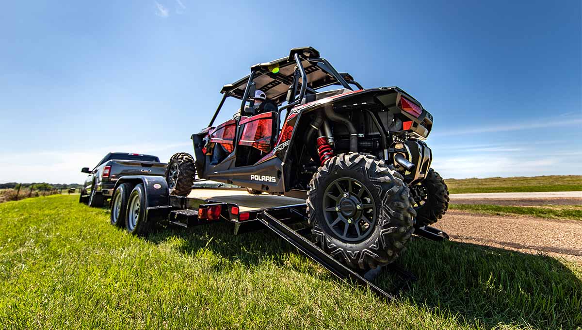 a polaris atv is being towed by a truck