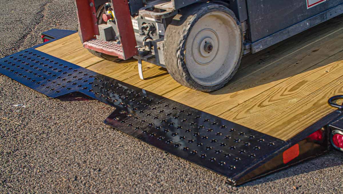 a forklift is sitting on a wooden ramp