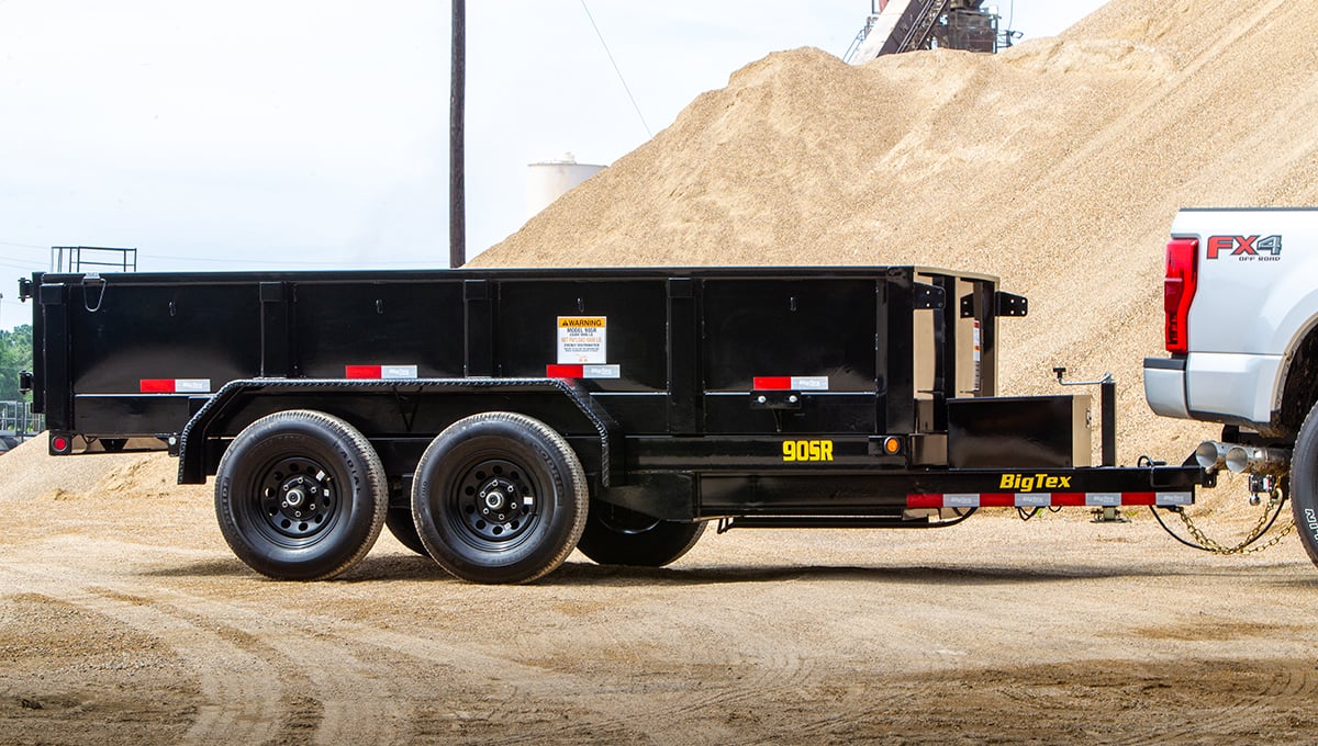 a 90sr big tex dump trailer is attached to a white truck