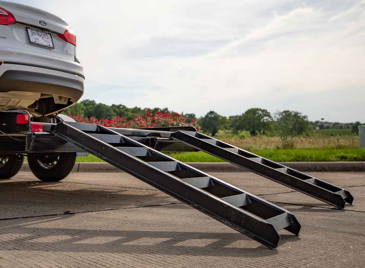 Slide In Ramps on Trailer That is Carrying a Car