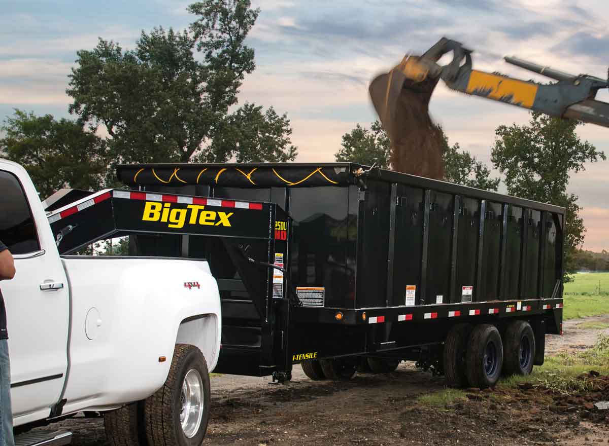 Excavator Pouring into Big Tex Sump Trailer