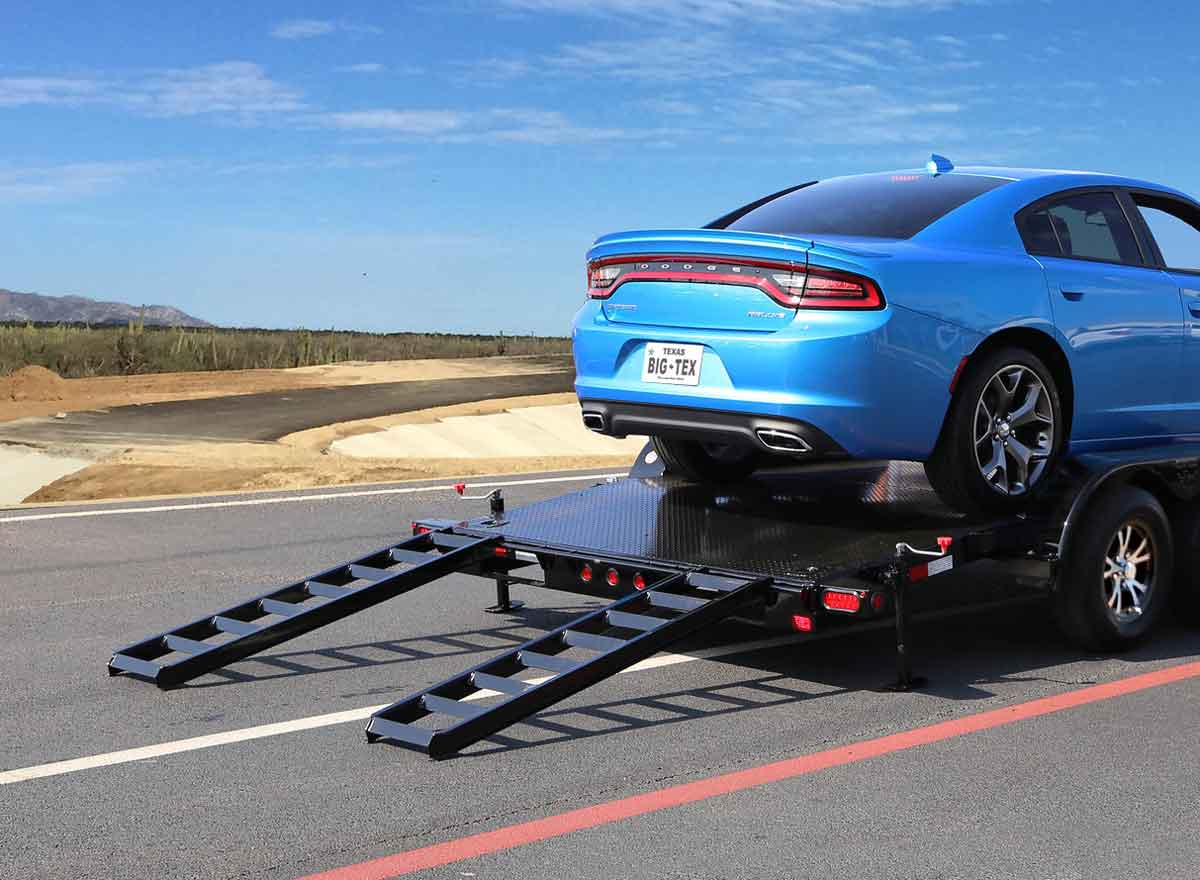 Slide-In Ramp on Trailer Carrying Blue Car