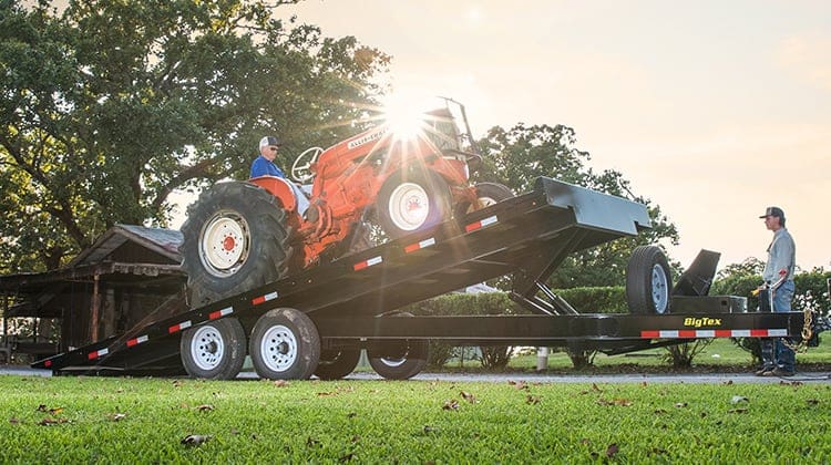 Big Tex Deck Over Tilt Trailer Carrying a Tractor